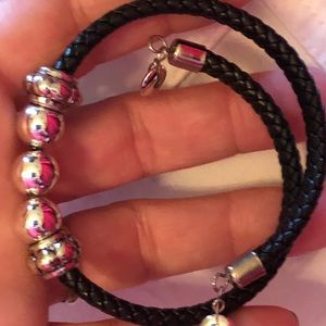 Silver colored beads on faux leather bracelet